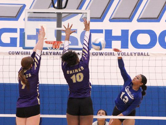 Edna senior Shanti Guerra attacks a double block by Shiner’s Lexi Boner, left, and Nevaeh Jones during Tuesday’s non-district match.