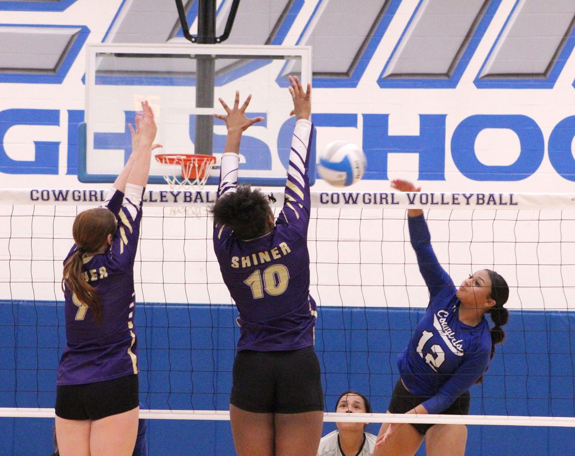 Edna senior Shanti Guerra attacks a double block by Shiner’s Lexi Boner, left, and Nevaeh Jones during Tuesday’s non-district match.